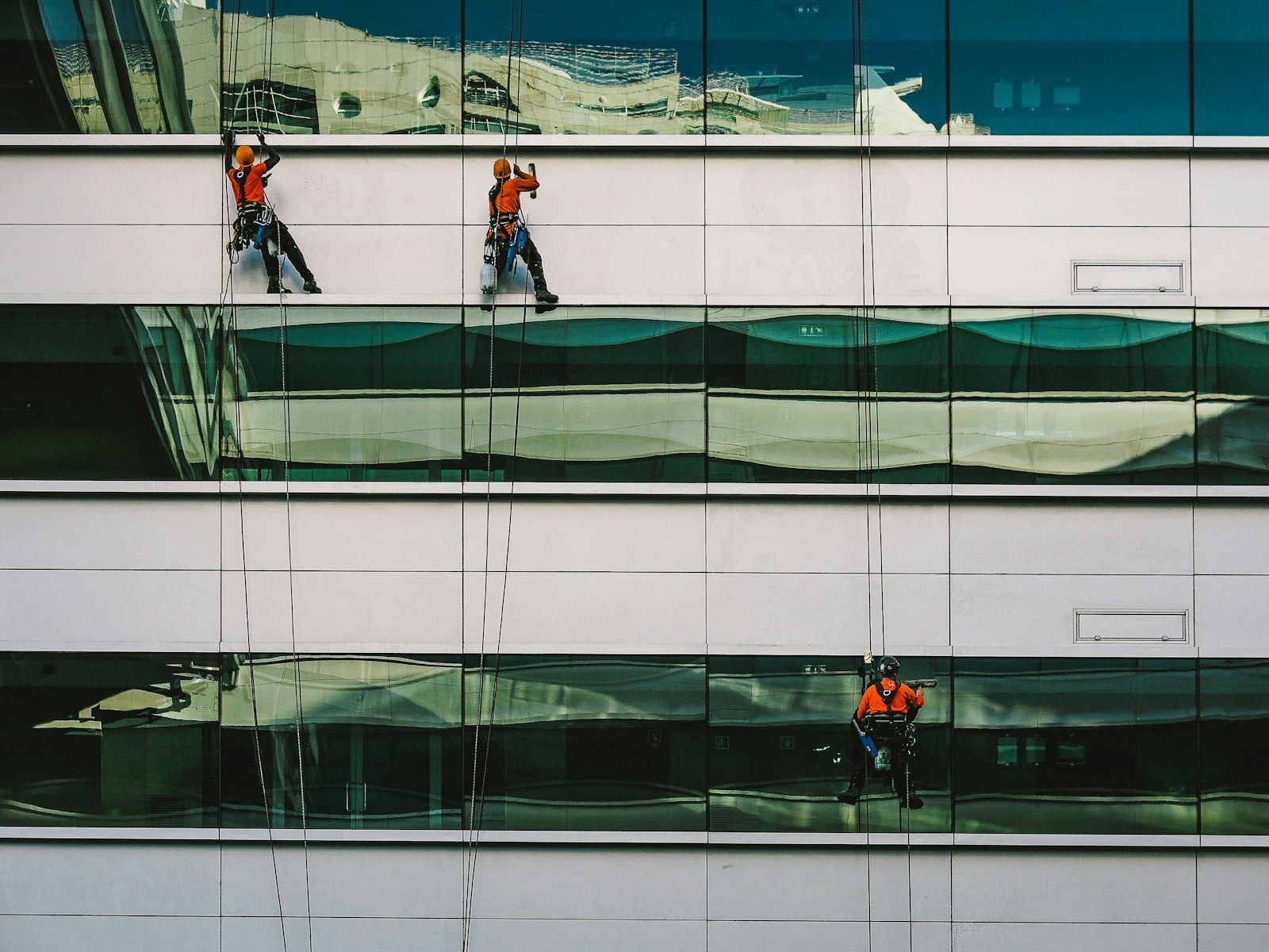 Cleaners working on the exterior windows of a building